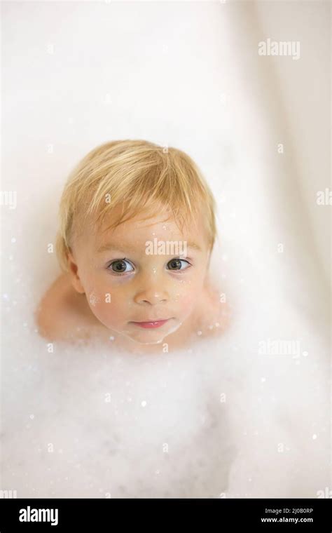 Little Boy In Bath In The Bathroom Child Bathing With A Lot Of Foam