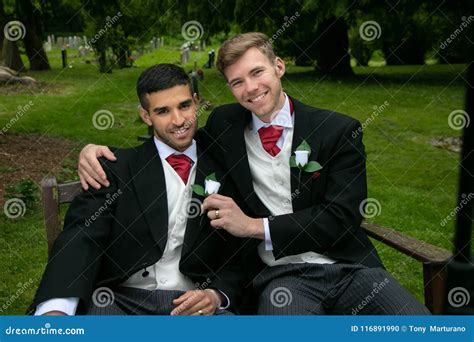Gay Weddings Grooms Couples Pose For Pictures After Their Wedding Ceremony In Churchyard Stock