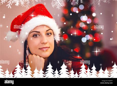 Composite Image Of Festive Brunette Wearing A Santa Hat Stock Photo Alamy