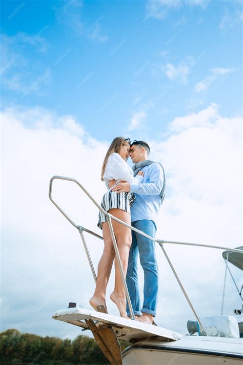 Premium Photo | Young couple hugging on deck of sailboat. romantic