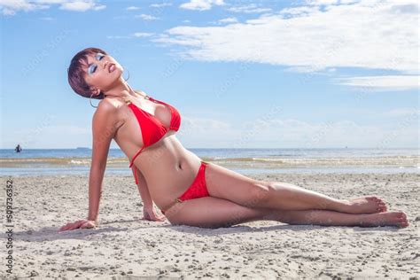 Sexy Asian Red Bikini Female Lady Model Having A Great Holiday By A Beach And Posing Happily