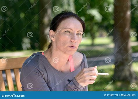 Mature Woman Smoking Cigarette On Bench In Park Stock Photo Image Of Middle Portrait