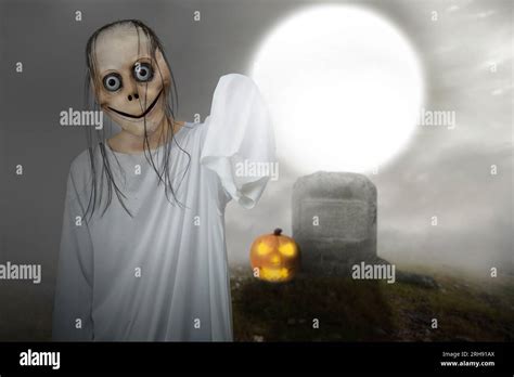 Scary Momo Standing In The Graveyard With A Night Scene Background