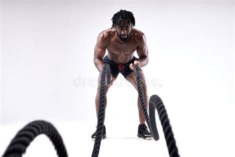 Powerful Muscular Man Working Out With Heavy Ropes Sporty Male With Naked Torso Stock Image