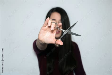 Beautiful Brunette Woman With Long Hair Showing The Scissors To The Camera Stock Photo Adobe