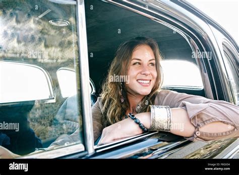 Mixed race woman driving vintage car Stock Photo - Alamy