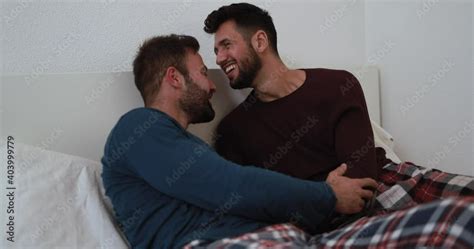 Gay Men Couple Hugging And Kissing Each Other At Home In Bedroom Homosexual Love And