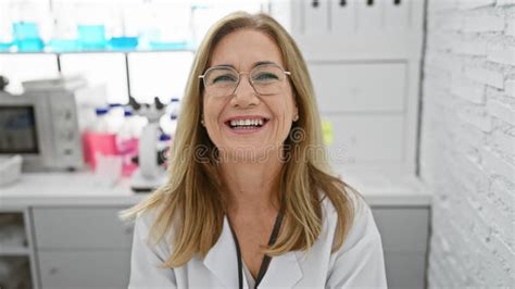 Fun Loving Middle Age Blonde Woman Scientist Sitting In The Lab