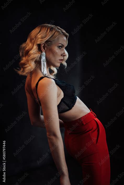 Portrait Of Candid Authentic Elegant Sexy Model Blonde Girl Posing In Bra And Red Pantsuit At