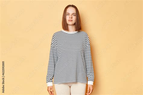 Serious Strict Brown Haired Woman Wearing Striped Shirt Standing