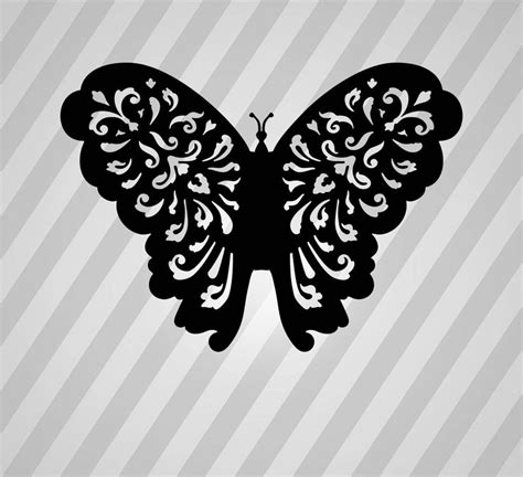 a black and white butterfly with floral designs on it's wings, against ...