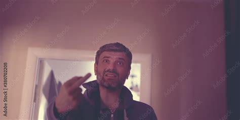 Angry Man Show Middle Finger Of Hand Fuck You Sign In Room Of Residential House Stock Photo
