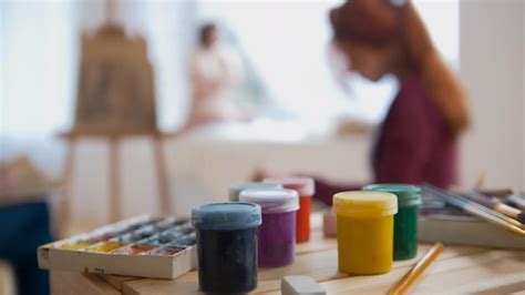 Premium Photo Paints And Art Supplies In Front Of Artists Performing Artistic Etude Witn Naked