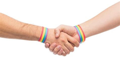 Premium Photo Hands With Gay Pride Wristbands Make Handshake