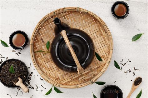Cup Of Hot Tea With Teapot Green Tea Leaves And Dried Herbs Top View