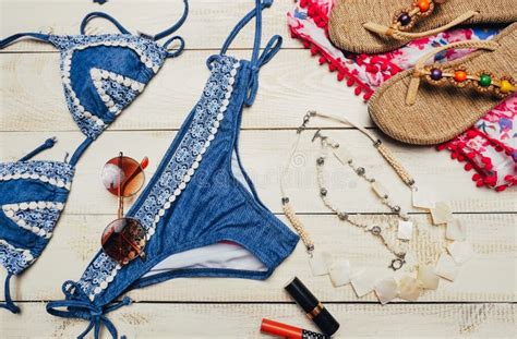 Flat Lay Of Summer Fashion With Blue Bikini Swimsuit And Girl Accessories On White Wooden