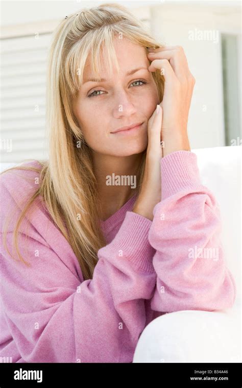 Blonde Woman In A Pink Sweater Posing Outdoors Stock Photo Alamy