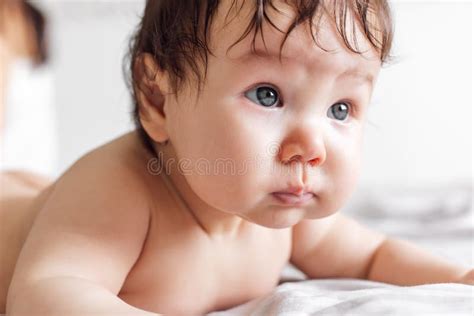 Portrait Of Naked Baby Lying On Bed Blanket At Home Blurred White Background Pretty Infant