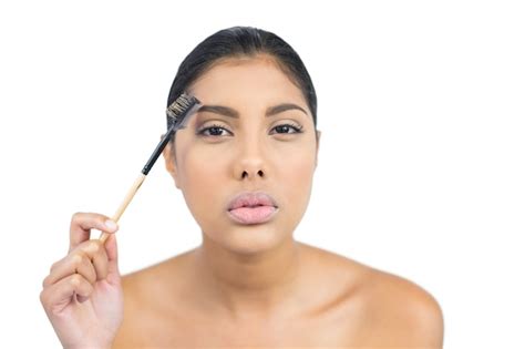 Premium Photo Serious Nude Brunette Using Eyebrow Brush