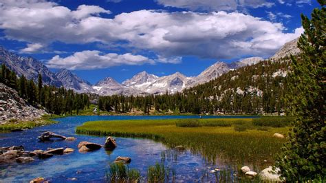 Beautiful Landscape Scenery River Grass, Mountains And White Clouds ... 