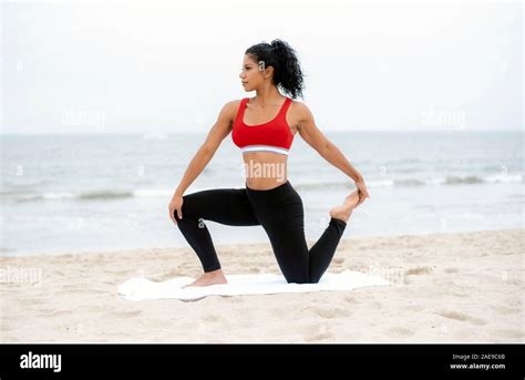 Fit Latina Athlete Stretches During A Workout At The Beach Stock Photo Alamy