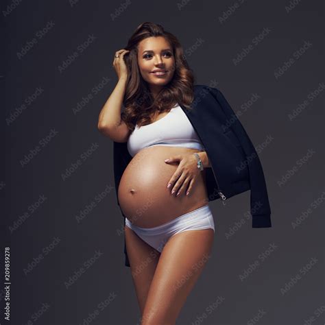 Full Body Portrait Of Attractive Smiling Pregnant Brunette Woman With Slightly Curly Hair
