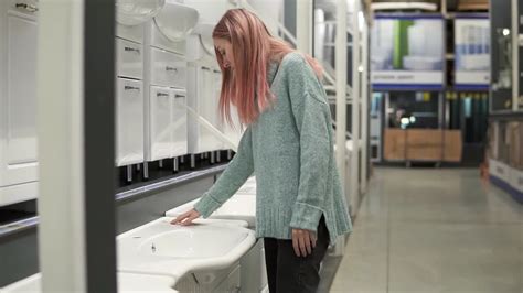 Premium Stock Video Blonde Woman Is Choosing A New Ceramic Sink In A Store