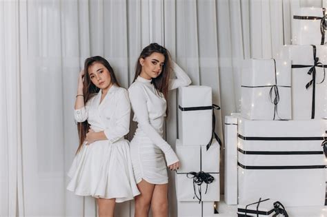 Premium Photo Two Beautiful Models A Redhead And A Brunette In New Year S Dresses Having Fun