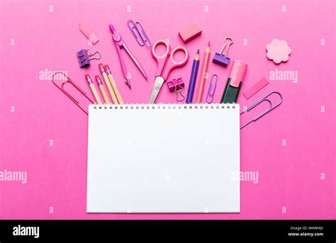 School supplies pink, purple color and blank white notebook on pink ...