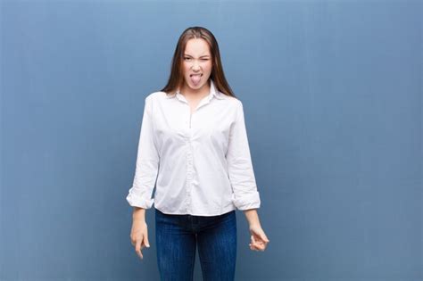 Premium Photo Portrait Of A Young Woman On A Blue Background