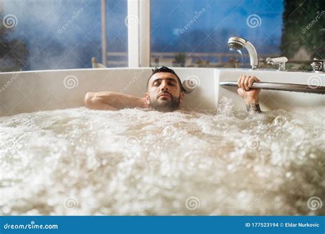 Man Relaxing At Home In The Hot Tub Bath Ritual Spa Day Moment In Modern Bathroom Indoors