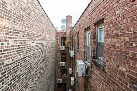 Premium Photo Narrow Lane Between Brick Houses