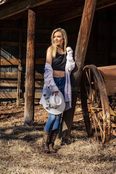 Lovely Blonde Model In Western Gear Poses Outdoor While Enjoying The Spring Weather Stock Image