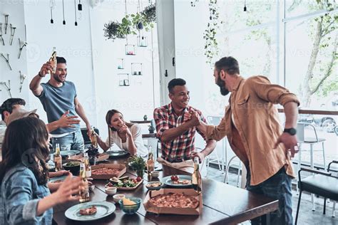 Friendship that lasts forever. Handsome young man toasting and smiling