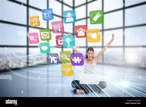 Digital Composite Of Cheering Blonde Using Laptop With App Icons Stock