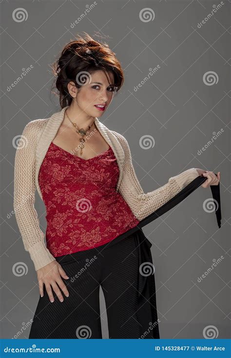 Gorgeous Brunette Model Poses In A Studio Environment Against A Dark Background Stock Image