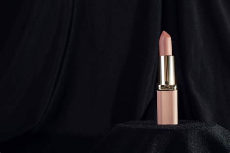 Premium Photo Nude Matte Lipstick On Podium On Black Background In A Pink And Gold Tube Top