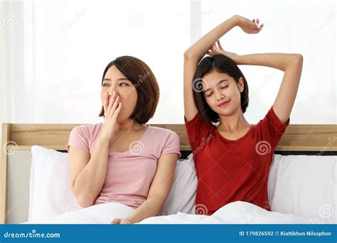 Lesbian Happy Couple Waking Up In Morning With Alarm Clock Having A Good Day Stock Photo Image