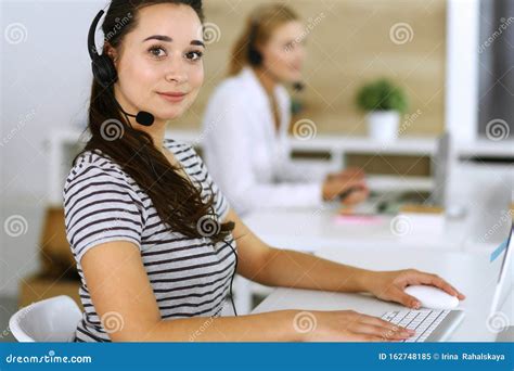 Business Woman Using Headset For Communication And Consulting People At