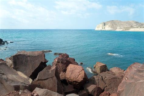 Premium Photo | Beach with red sand the island of santorini