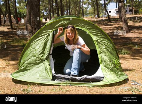 A Blonde Woman Enjoys Camping In A Green Tent Stock Photo Alamy
