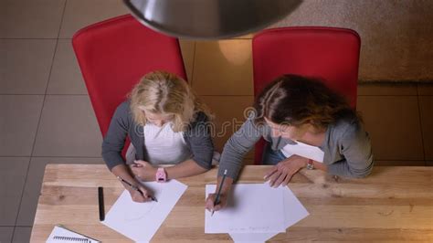 Closeup Top View Of Small Pretty Blonde Girl Learning How To Draw While Mother Giving Her A