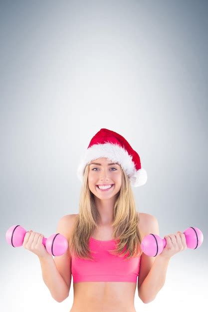 Premium Photo Festive Fit Blonde Holding Dumbbells On Vignette Background