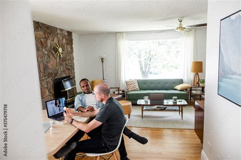 Gay Male Couple Video Chatting With Doctor At Dining Table Stock Photo Adobe Stock