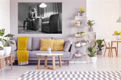 Two Chic Naked Women In An Erotic Pose Are Sitting On A Chair In A Bright Room Interior
