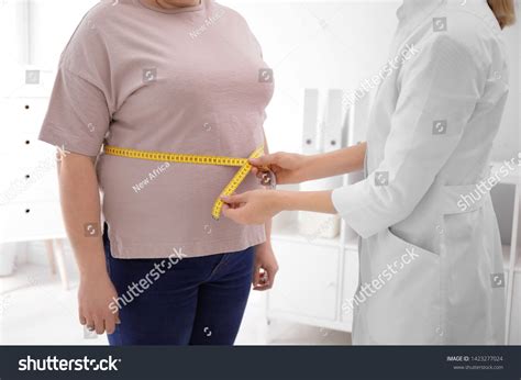 Doctor Measuring Waist Overweight Woman Clinic Stock Photo 1423277024