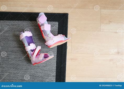 Child Cerebral Palsy Disability Legs Orthosis Shoes On A Floor At Home