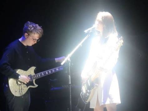 Two People Are Playing Guitars On Stage