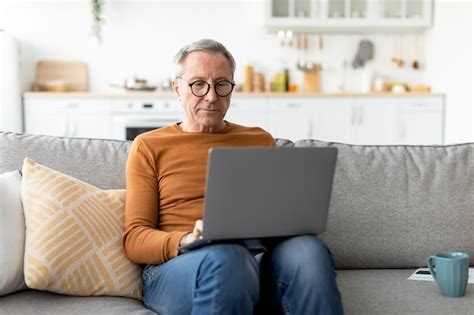 Premium Photo Confident Casual Mature Male Using Laptop At Home