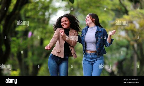 Fun Happy Two Diverse Girlfriends Jumping And Dancing In Joy People